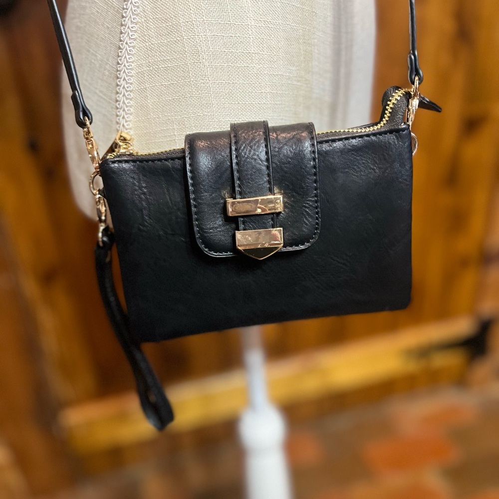 Madison West black wristlet 5” high by 7” wide with shoulder strap 1334